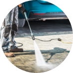 man pressure washing driveway