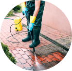man pressure washing walkway